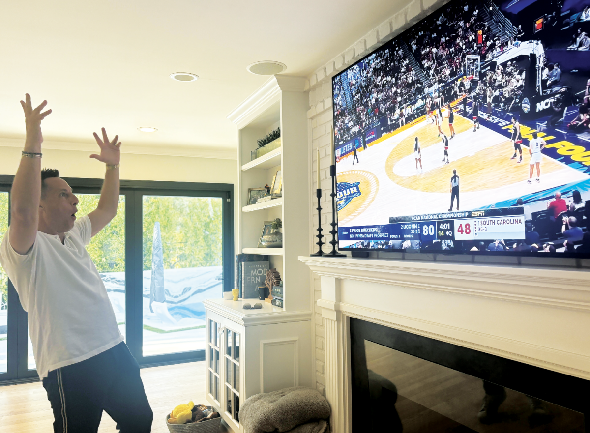 Cheering on the team: Jared Green watches with excitement the WNCAA during March Madness